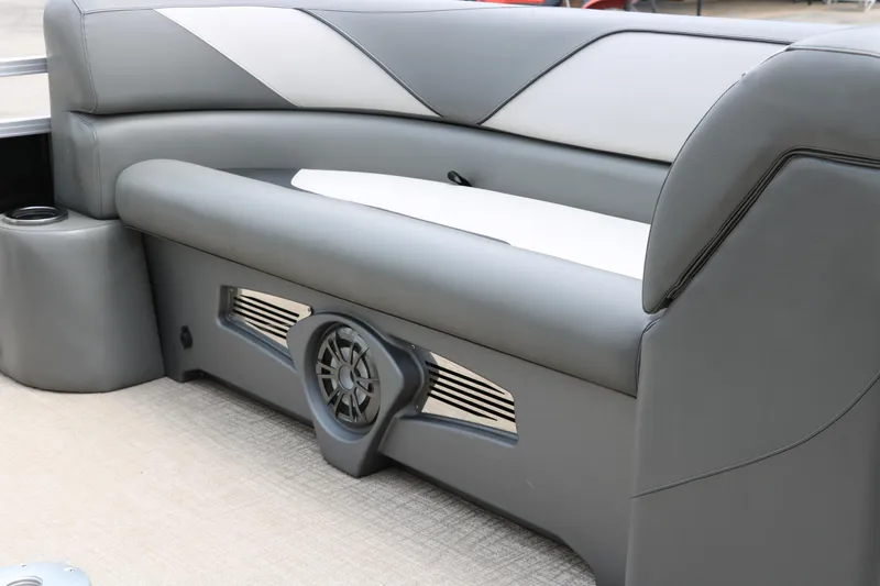 Slide: The Image of 2023 Avalon Venture 2385 RF pontoon boat interior with gray seating and captain's chair. - 27