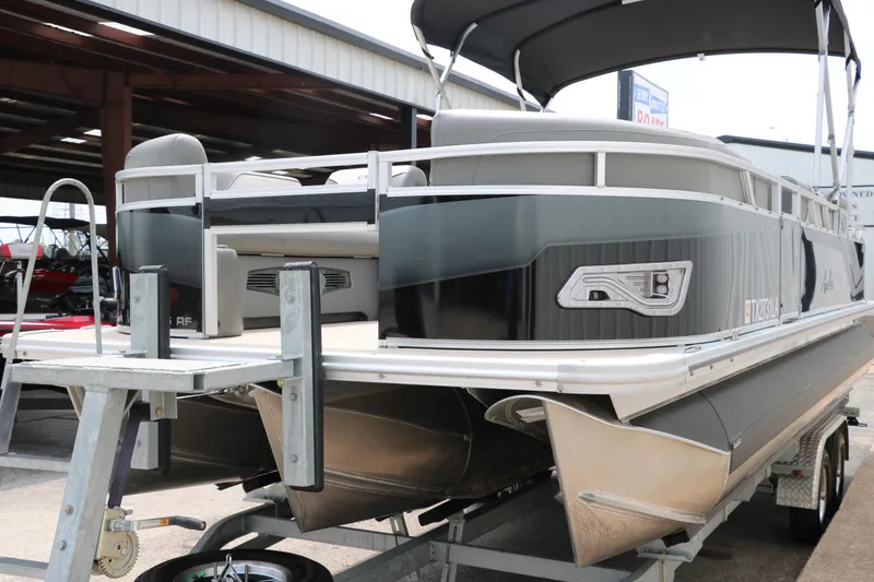 Slide: The Image of 2023 Avalon Venture 2385 RF pontoon boat on trailer, rear view with ladder. - 8