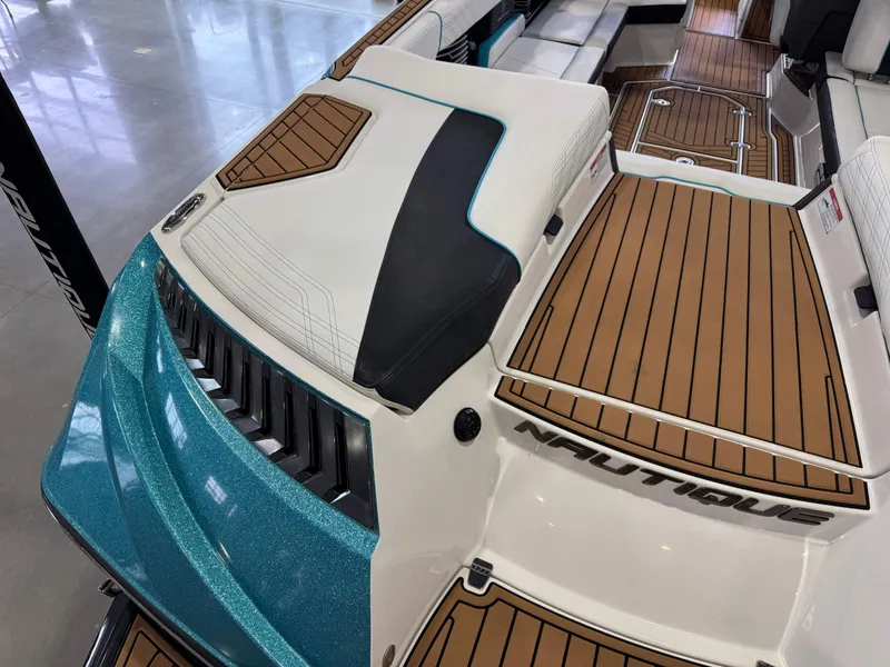 Slide: The Image of 2019 Nautique Super Air Nautique G25 interior with teak flooring and sleek design. - 12