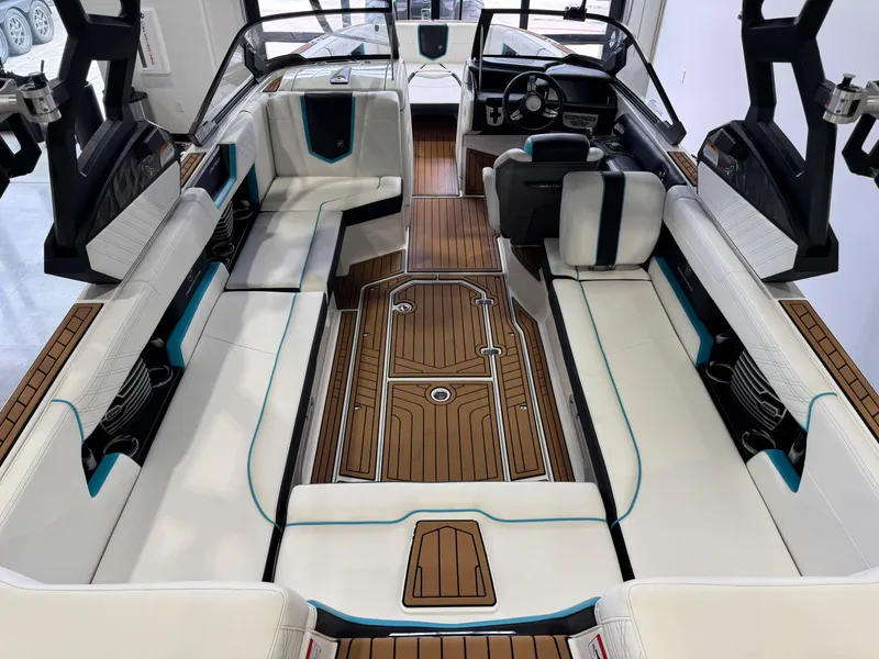 Slide: The Image of 2019 Nautique Super Air Nautique G25 interior with white seating and wood accents. - 13