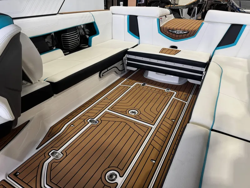 Slide: The Image of 2019 Nautique Super Air Nautique G25 interior with teak flooring and white seating. - 15