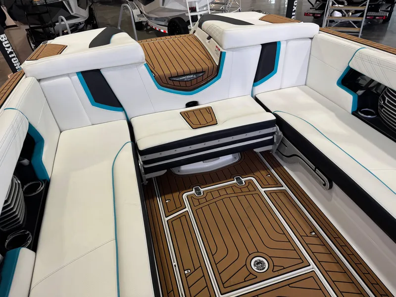 Slide: The Image of 2019 Nautique Super Air Nautique G25 interior with white seating and teak flooring. - 16