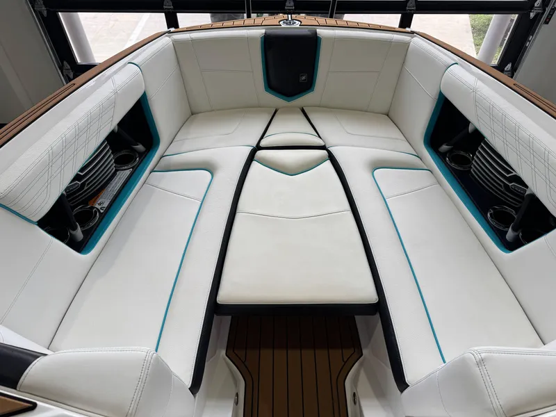 Slide: The Image of 2019 Nautique Super Air Nautique G25 interior with white seating and teal accents. - 17