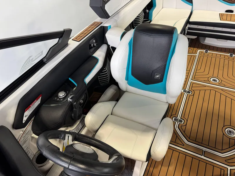 Slide: The Image of 2019 Nautique Super Air Nautique G25 interior with steering wheel and seating. - 21