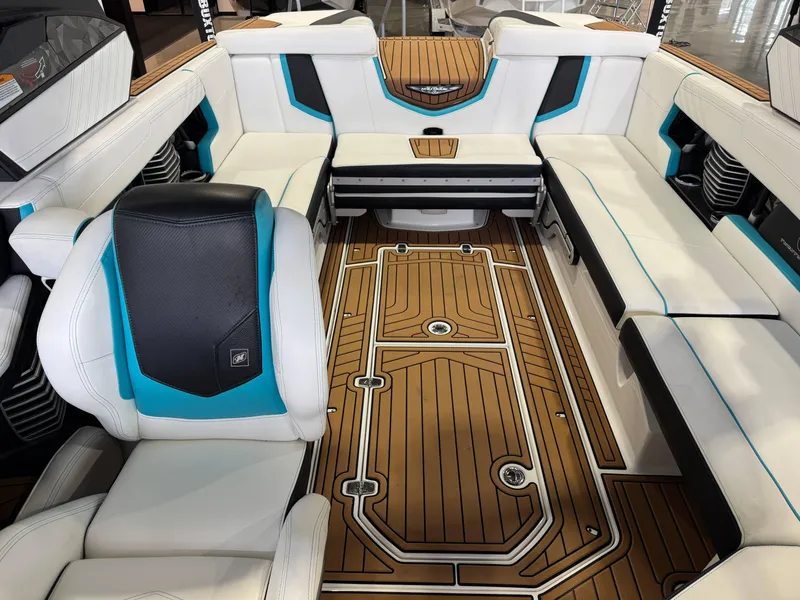 Slide: The Image of 2019 Nautique Super Air Nautique G25 interior with luxurious seating and teak-style flooring. - 22