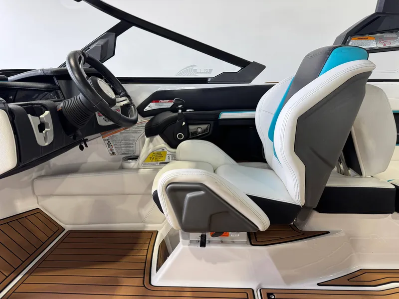Slide: The Image of 2019 Nautique Super Air Nautique G25 interior with steering wheel and seating. - 23