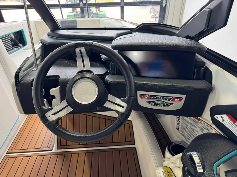 Slide: The Image of 2019 Nautique Super Air Nautique G25 dashboard with steering wheel and control panel. - 26
