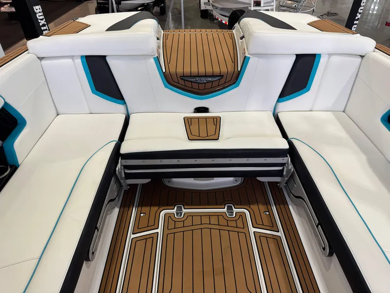 Slide: The Image of 2019 Nautique Super Air Nautique G25 interior with white seating and teak flooring. - 27