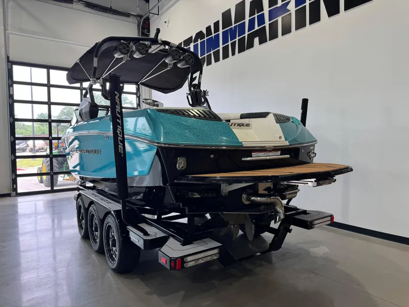 Slide: The Image of 2019 Nautique Super Air Nautique G25 boat in showroom, featuring sleek design and vibrant color. - 5