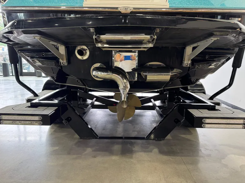 Slide: The Image of 2019 Nautique Super Air Nautique G25 boat stern with propeller and exhaust system. - 7