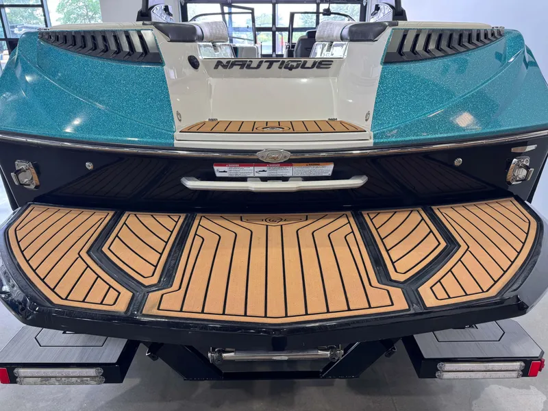 Slide: The Image of 2019 Nautique Super Air Nautique G25 boat with teak deck, rear view. - 8