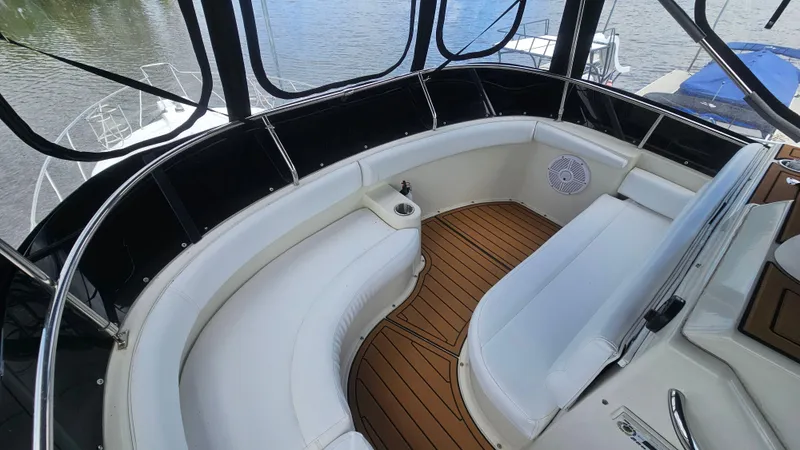 Slide: The Image of 1995 Silverton 41 Convertible boat interior with white seating and wood flooring. - 10