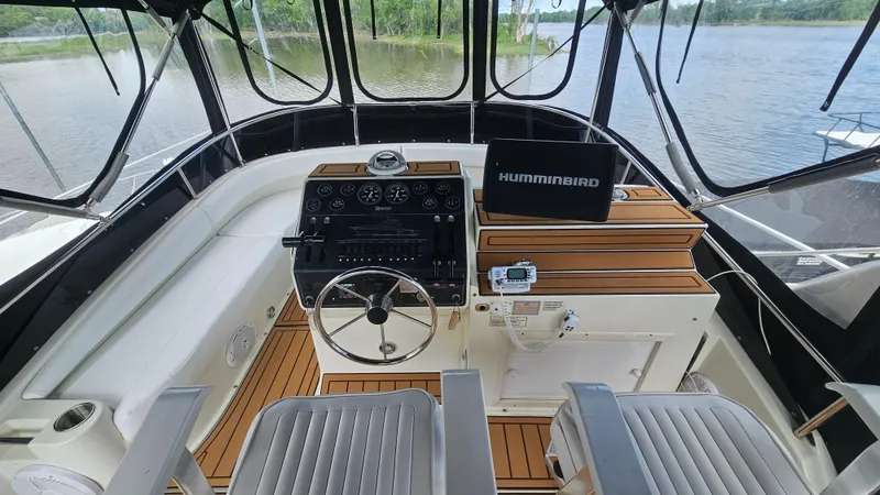Slide: The Image of 1995 Silverton 41 Convertible boat helm with steering wheel and navigation equipment. - 12