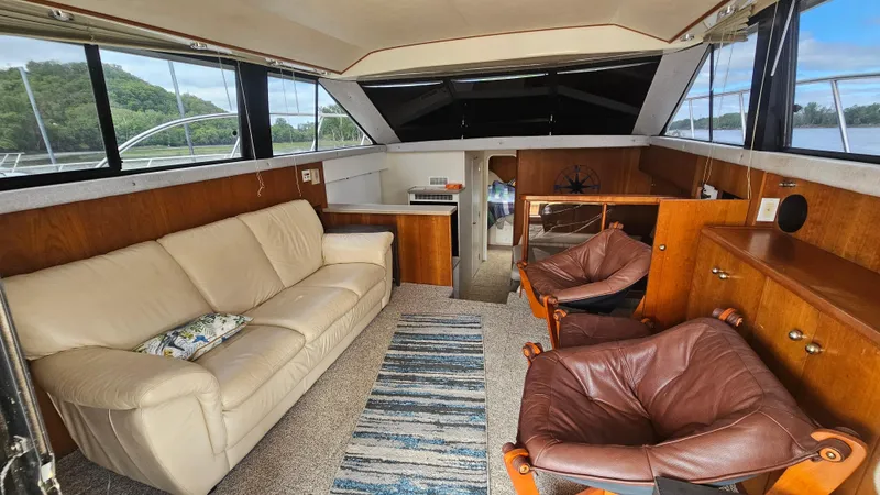 Slide: The Image of Interior of a 1995 Silverton 41 Convertible yacht with leather seating and wood accents. - 15