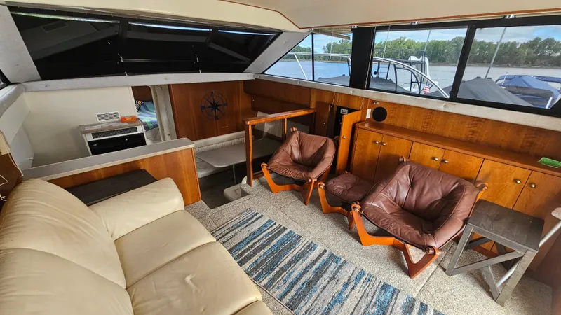 Slide: The Image of Interior of 1995 Silverton 41 Convertible yacht with leather seating and wooden cabinetry. - 16