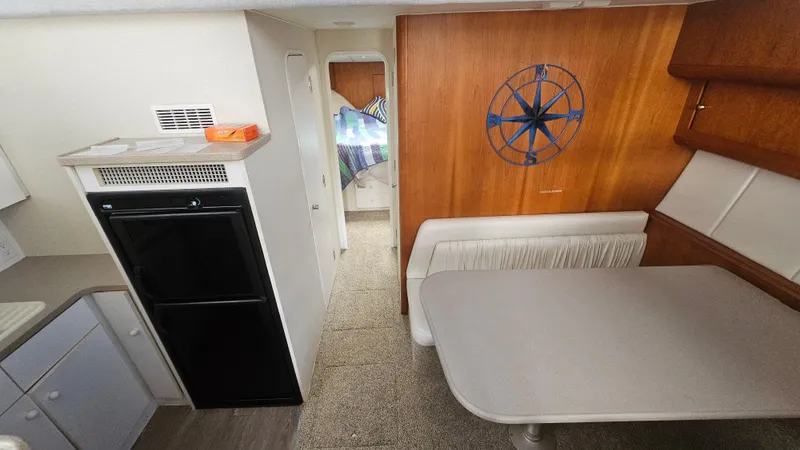 Slide: The Image of Interior of 1995 Silverton 41 Convertible yacht with dining area and kitchenette. - 22