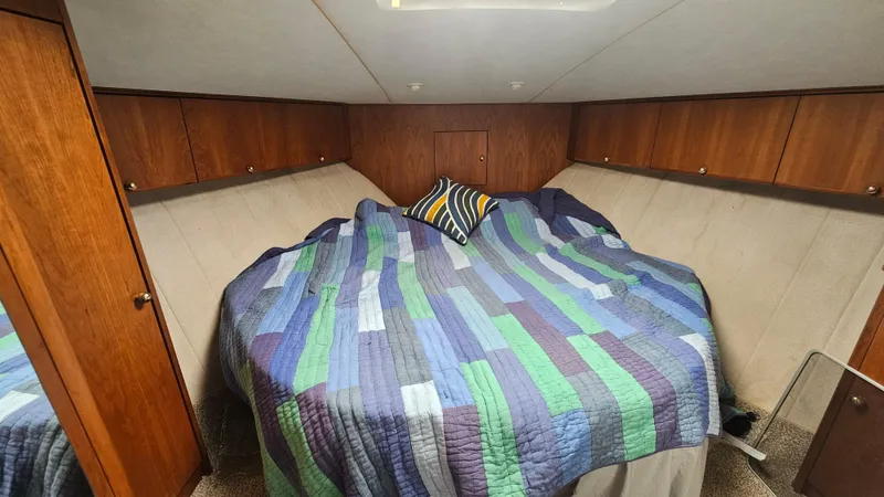 Slide: The Image of Cozy cabin interior of 1995 Silverton 41 Convertible with colorful quilted bedding. - 23