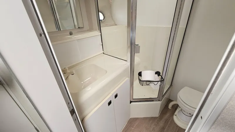 Slide: The Image of Bathroom interior of 1995 Silverton 41 Convertible yacht with sink, shower, and toilet. - 26
