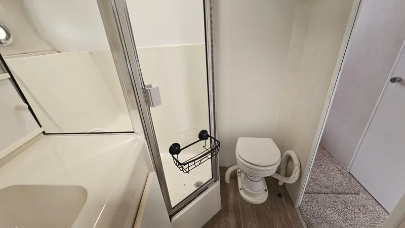 Slide: The Image of 1995 Silverton 41 Convertible bathroom with shower, toilet, and modern fixtures. - 28