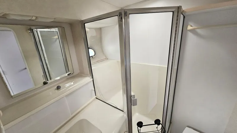 Slide: The Image of Bathroom interior of 1995 Silverton 41 Convertible yacht with shower and mirror. - 29