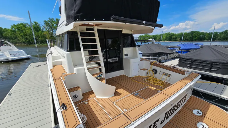 Slide: The Image of 1995 Silverton 41 Convertible yacht docked, featuring spacious deck and modern design. - 6