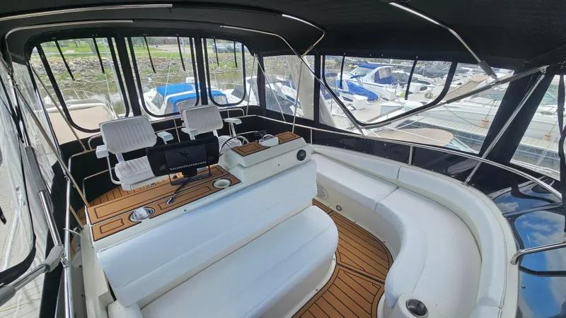 Slide: The Image of 1995 Silverton 41 Convertible yacht interior with helm, seating, and wood flooring. - 7