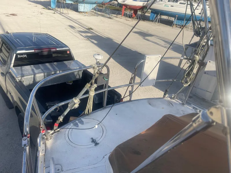 Slide: The Image of 1984 Hanseat 37 sailboat on trailer beside a parked truck in a boatyard. - 10