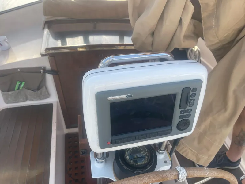 Slide: The Image of Cockpit of 1984 Hanseat 37 sailboat with navigation equipment and wooden details. - 12