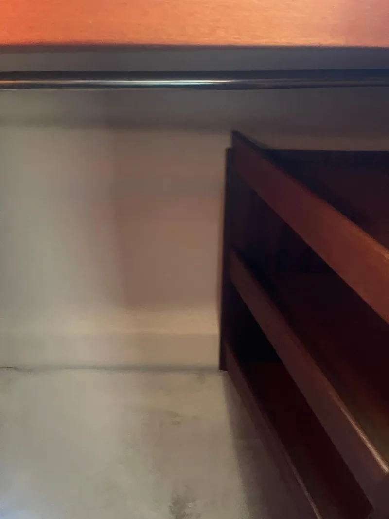 Slide: The Image of Interior view of a 1984 Hanseat 37 boat, featuring wooden shelves and a smooth surface. - 17