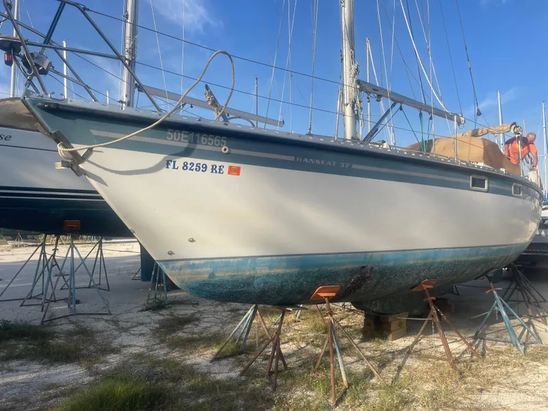 Slide: The Image of 1984 Hanseat 37 sailboat on stands, blue sky background, side view. - 2