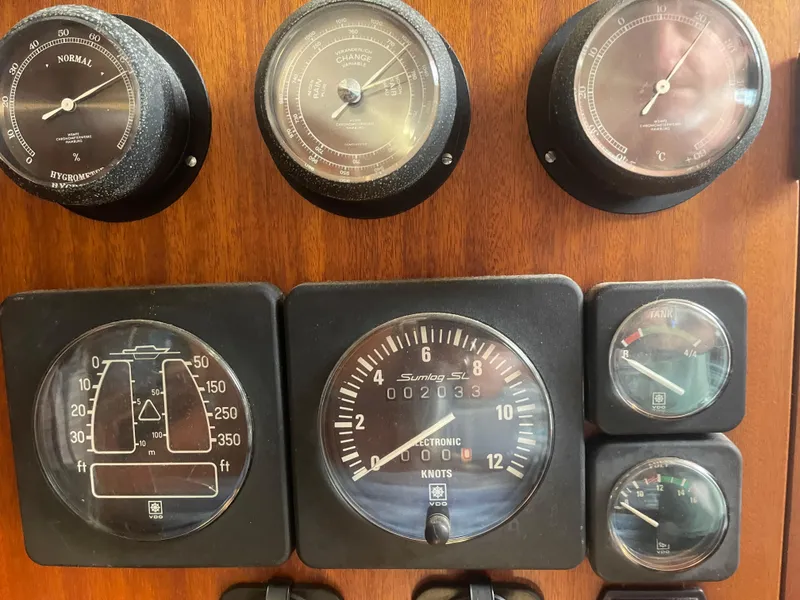 Slide: The Image of Control panel of a 1984 Hanseat 37 boat with various gauges and dials. - 25