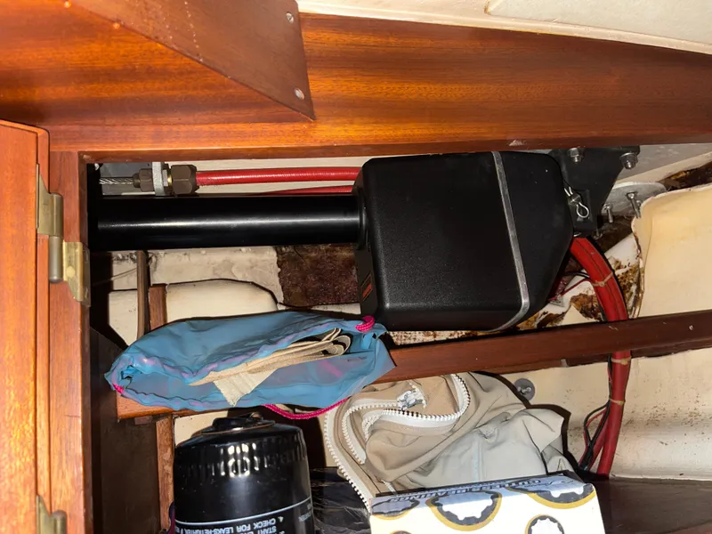 Slide: The Image of Storage compartment in a 1984 Hanseat 37 sailboat with various items and equipment. - 27