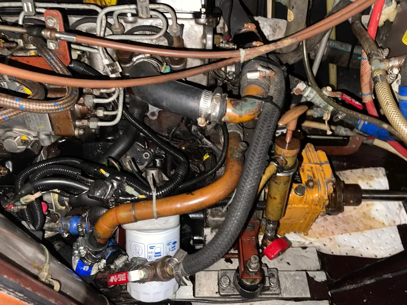 Slide: The Image of Engine compartment of a 1984 Hanseat 37, showcasing hoses and mechanical components. - 30