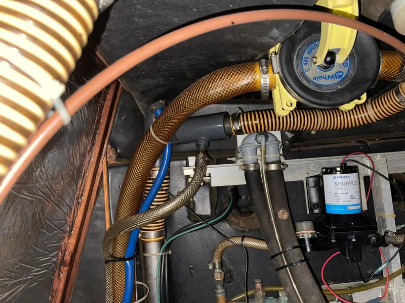 Slide: The Image of Engine compartment of a 1984 Hanseat 37, showcasing hoses and mechanical components. - 31