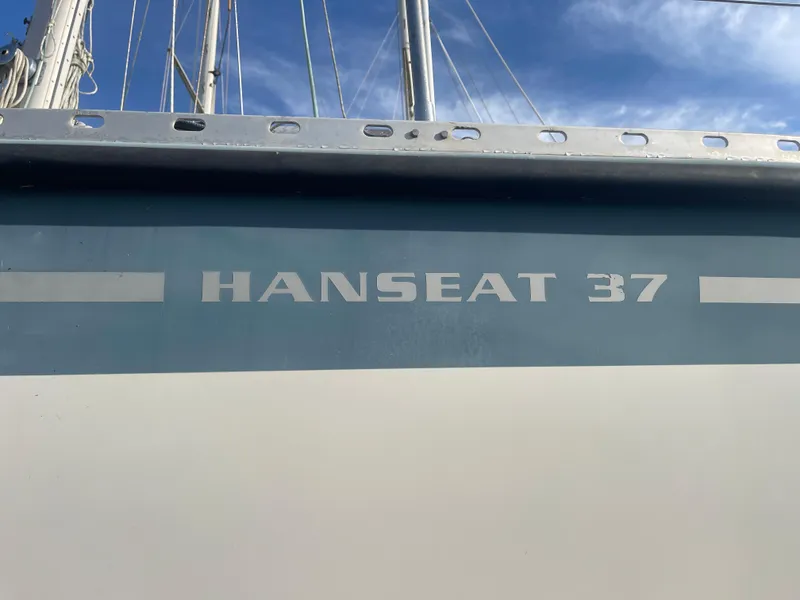 Slide: The Image of Hanseat 37 sailboat from 1984 with blue and white hull under a clear sky. - 6