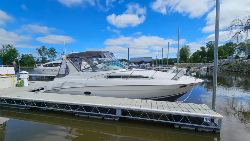 Slide: The Image of 1995 Regal Commodore 292 boat docked at marina under blue sky. - 1
