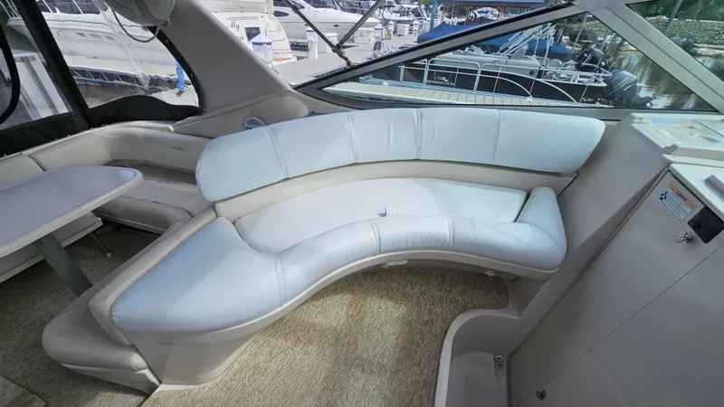 Slide: The Image of Interior of 1995 Regal Commodore 292 yacht with curved seating and table. - 10
