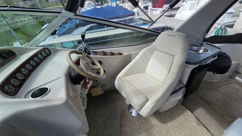 Slide: The Image of 1995 Regal Commodore 292 boat interior with steering wheel and captain's chair. - 11