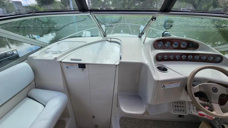 Slide: The Image of Interior view of a 1995 Regal Commodore 292 boat cockpit with steering wheel and gauges. - 14