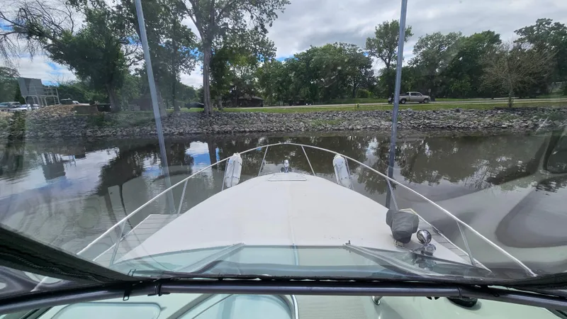 Slide: The Image of 1995 Regal Commodore 292 boat on calm water, view from the bow. - 15