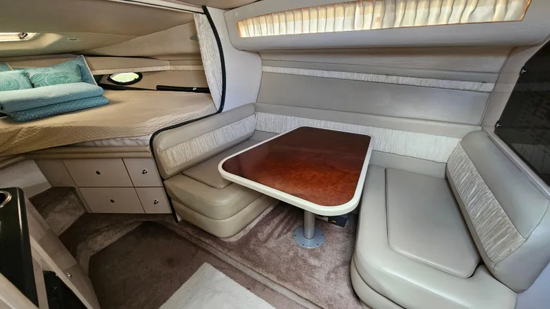 Slide: The Image of 1995 Regal Commodore 292 cabin interior with dining area and bed. - 17