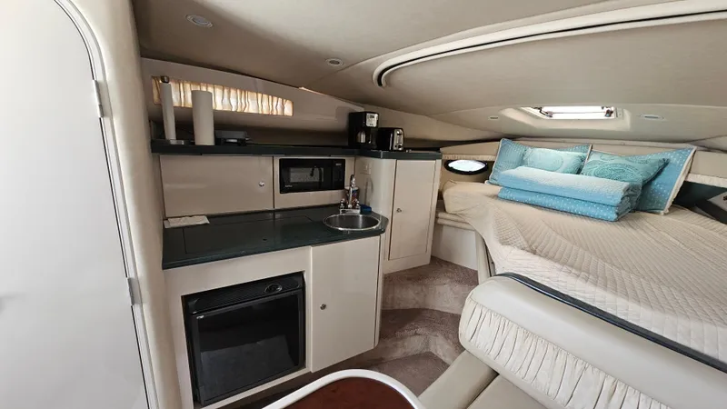 Slide: The Image of Interior of 1995 Regal Commodore 292 yacht with kitchenette and cozy sleeping area. - 19