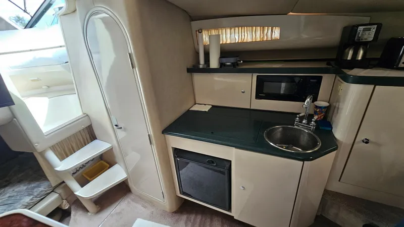 Slide: The Image of Interior of 1995 Regal Commodore 292 boat with kitchenette, sink, and microwave. - 20