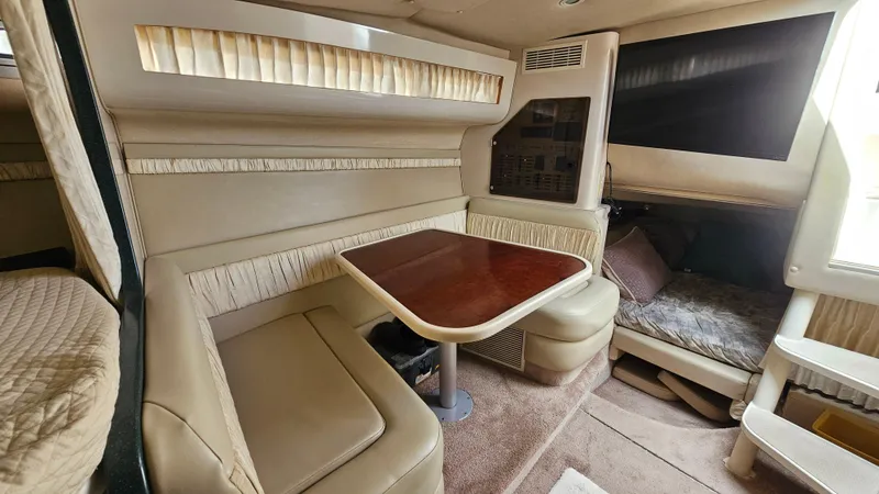 Slide: The Image of Interior of 1995 Regal Commodore 292 boat with dining area and cozy seating. - 22