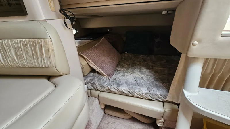 Slide: The Image of 1995 Regal Commodore 292 cabin interior with cozy bed and cushions. - 23