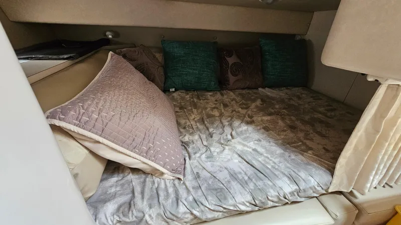 Slide: The Image of Cozy cabin interior of 1995 Regal Commodore 292 with plush bedding and decorative pillows. - 24
