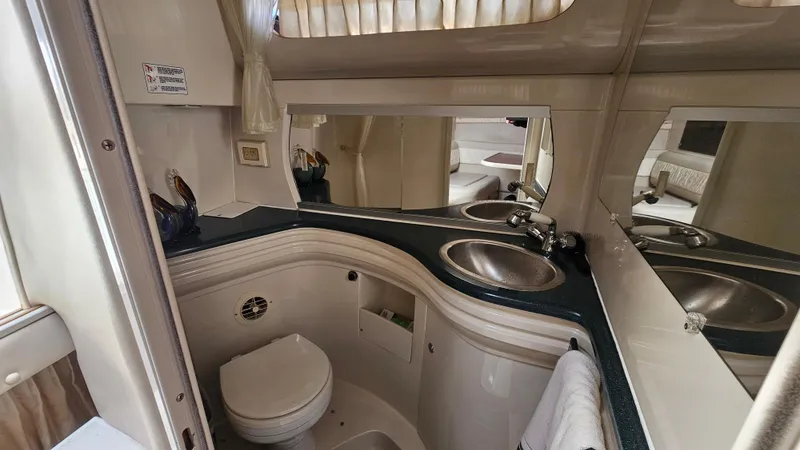 Slide: The Image of 1995 Regal Commodore 292 boat bathroom with sink, mirror, and toilet. - 25