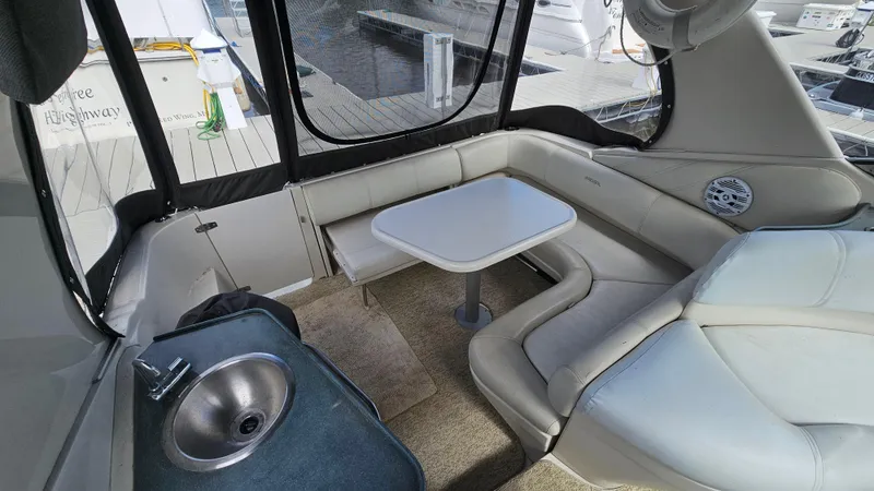 Slide: The Image of Interior of 1995 Regal Commodore 292 boat with seating, table, and sink. - 6