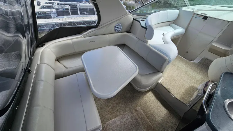 Slide: The Image of Interior of a 1995 Regal Commodore 292 boat with white seating and table. - 7