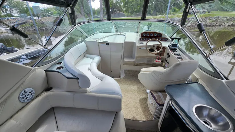 Slide: The Image of Interior of a 1995 Regal Commodore 292 boat with plush seating and steering console. - 8